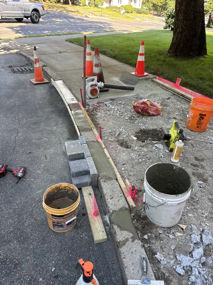 Marked concrete repair area with traffic cones