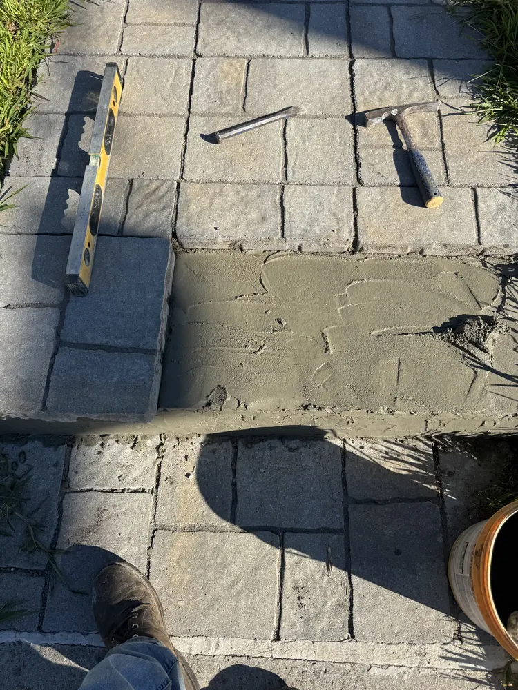 Stone pavers being set in a prepared base